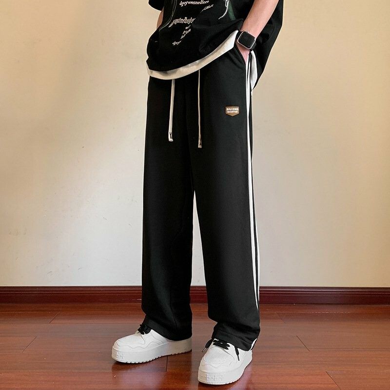 男性レジャー運動とベルベットの厚いコーデュロイ長ズボンのストレートゆるい長ズボン