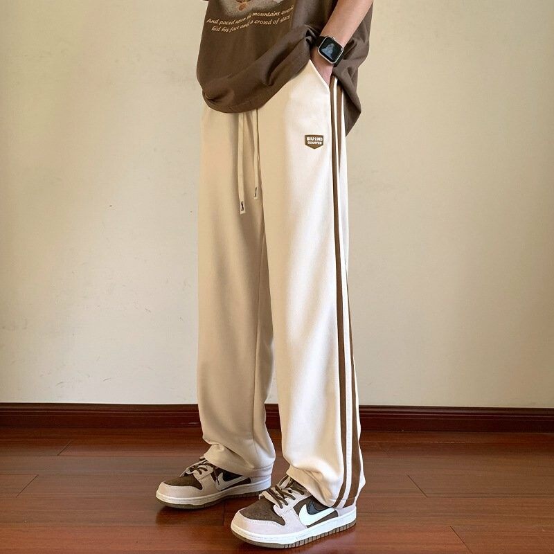 男性レジャー運動とベルベットの厚いコーデュロイ長ズボンのストレートゆるい長ズボン